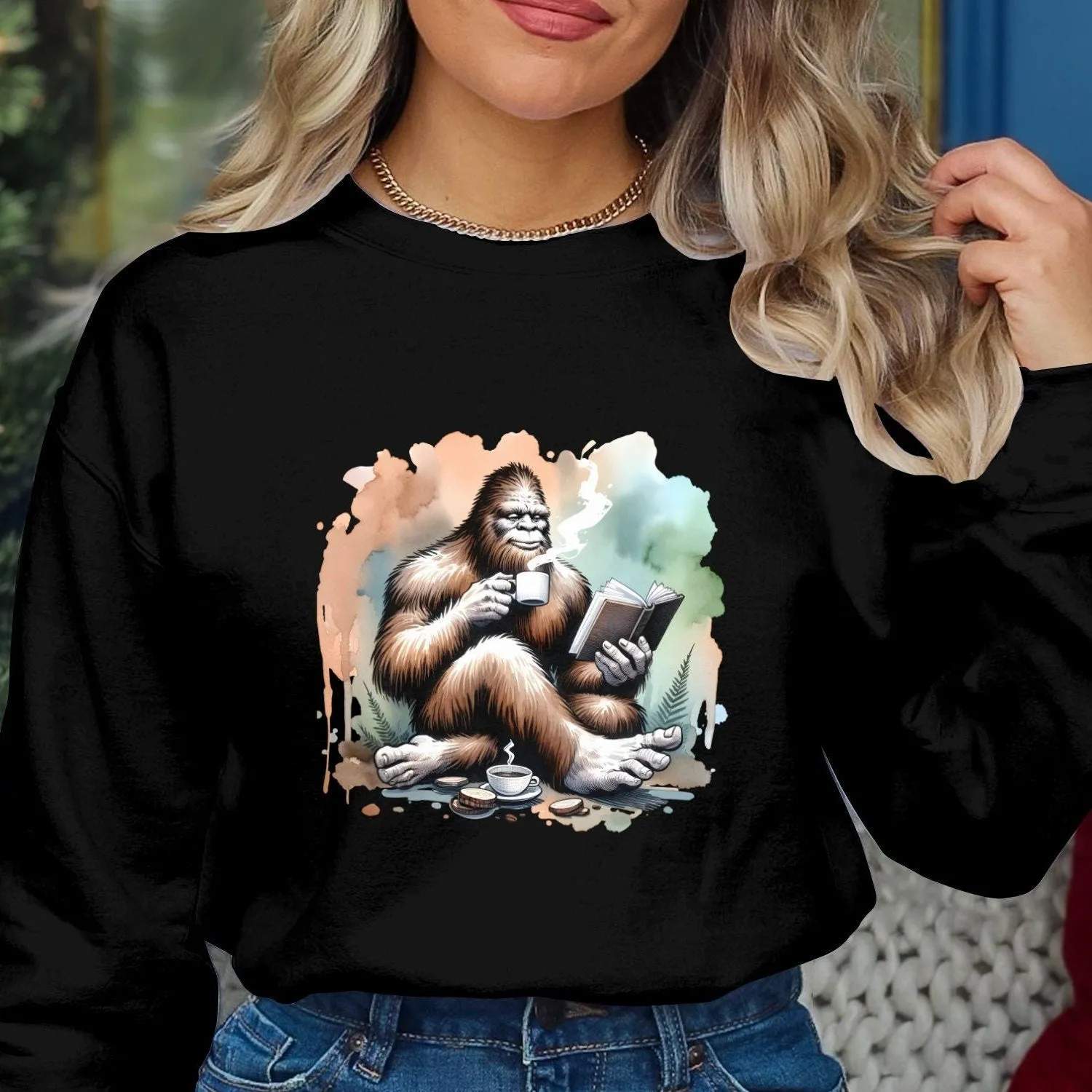 Bigfoot Reading Book T-Shirt, Cozy Sasquatch Tea Time Tee,Unique Cryptid Lovers Gift, Nature Inspired Graphic Shirt, Coffee Lover Sweatshirt