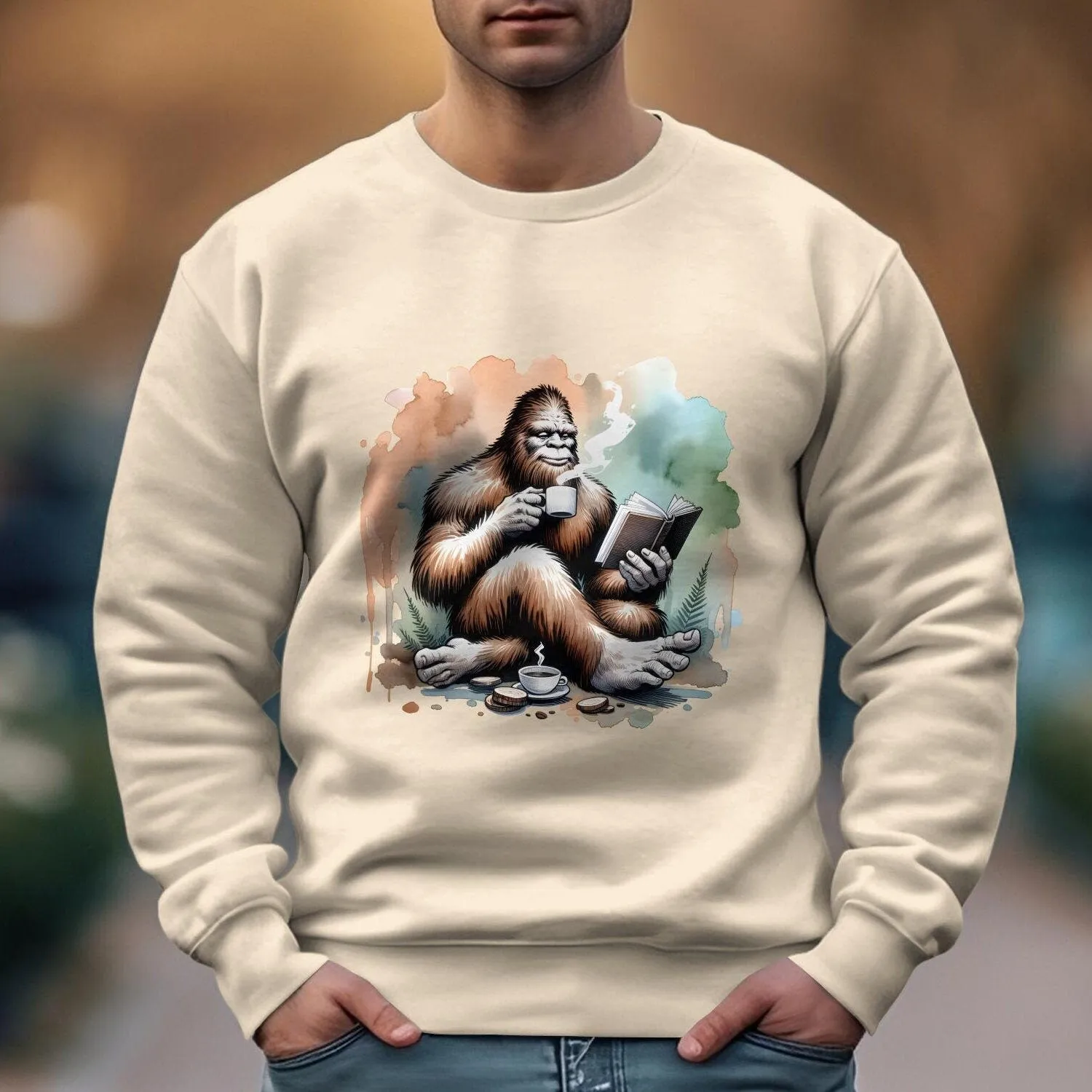 Bigfoot Reading Book T-Shirt, Cozy Sasquatch Tea Time Tee,Unique Cryptid Lovers Gift, Nature Inspired Graphic Shirt, Coffee Lover Sweatshirt