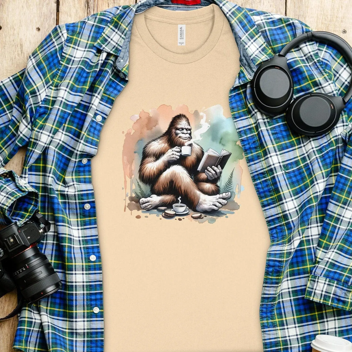 Bigfoot Reading Book T-Shirt, Cozy Sasquatch Tea Time Tee,Unique Cryptid Lovers Gift, Nature Inspired Graphic Shirt, Coffee Lover Sweatshirt