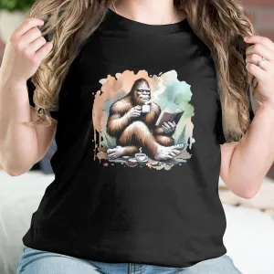 Bigfoot Reading Book T-Shirt, Cozy Sasquatch Tea Time Tee,Unique Cryptid Lovers Gift, Nature Inspired Graphic Shirt, Coffee Lover Sweatshirt