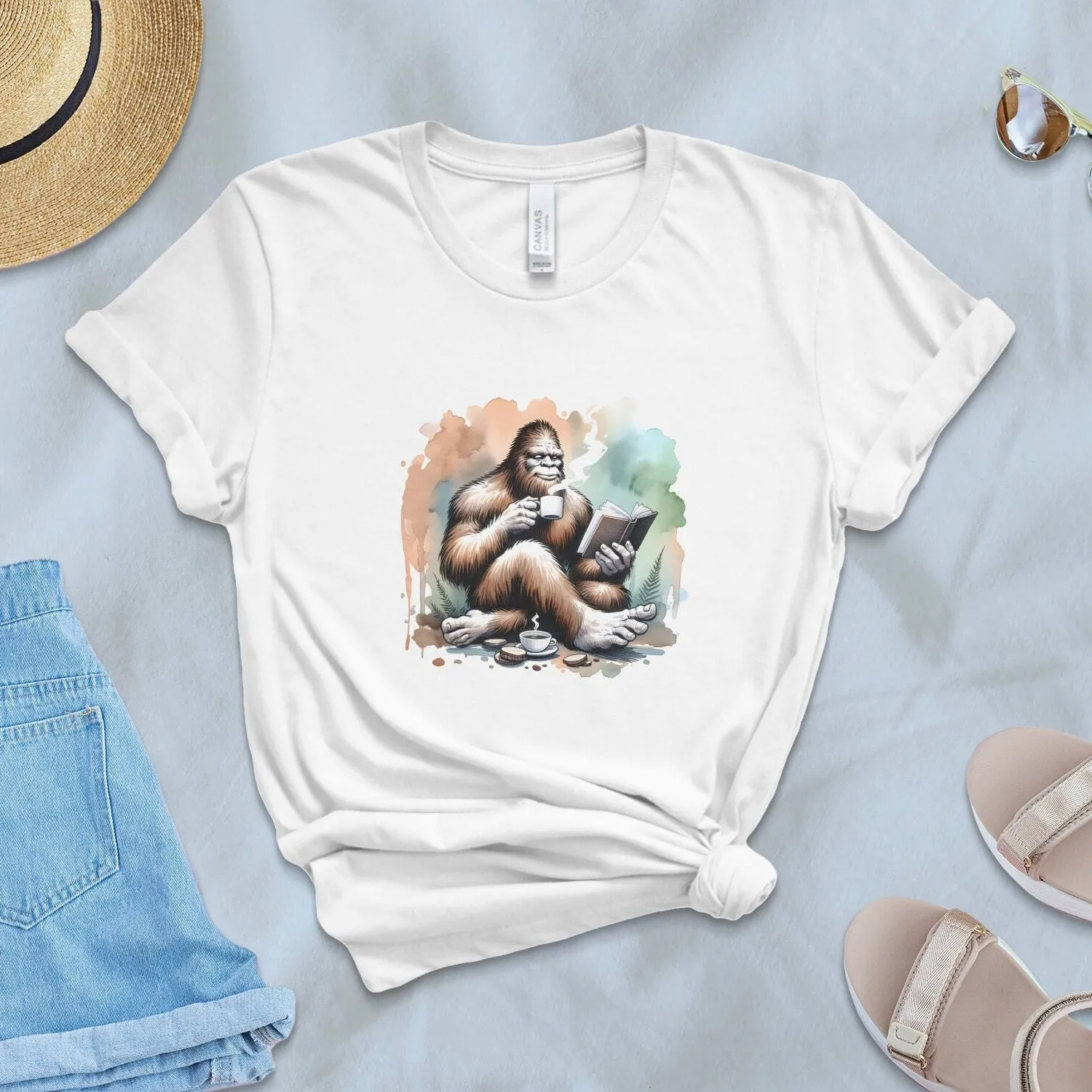 Bigfoot Reading Book T-Shirt, Cozy Sasquatch Tea Time Tee,Unique Cryptid Lovers Gift, Nature Inspired Graphic Shirt, Coffee Lover Sweatshirt