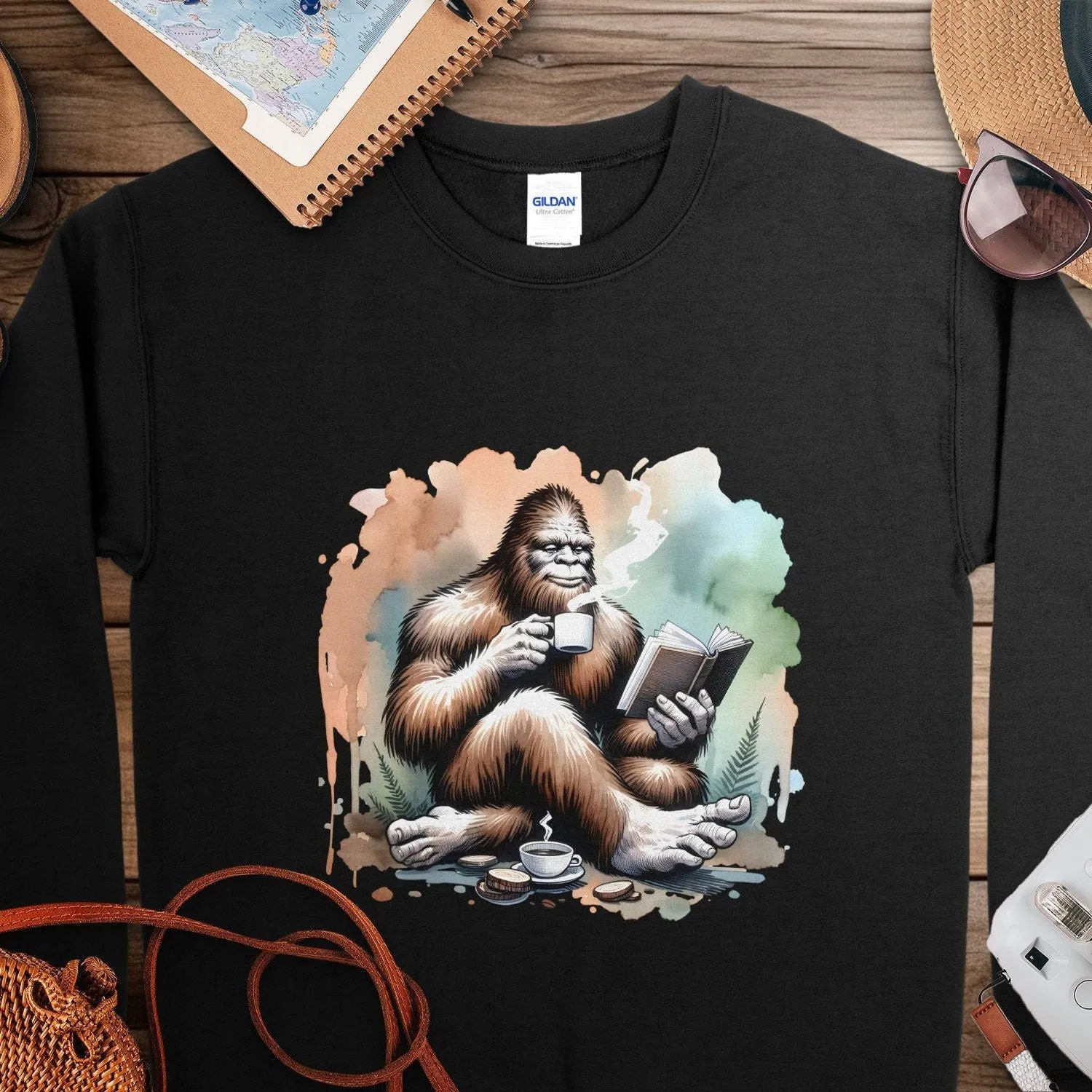 Bigfoot Reading Book T-Shirt, Cozy Sasquatch Tea Time Tee,Unique Cryptid Lovers Gift, Nature Inspired Graphic Shirt, Coffee Lover Sweatshirt